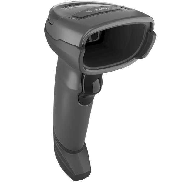 A close-up of a Zebra black cordless barcode scanner with a stand.