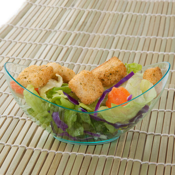 A Fineline green plastic tureen filled with a salad with croutons and lettuce.