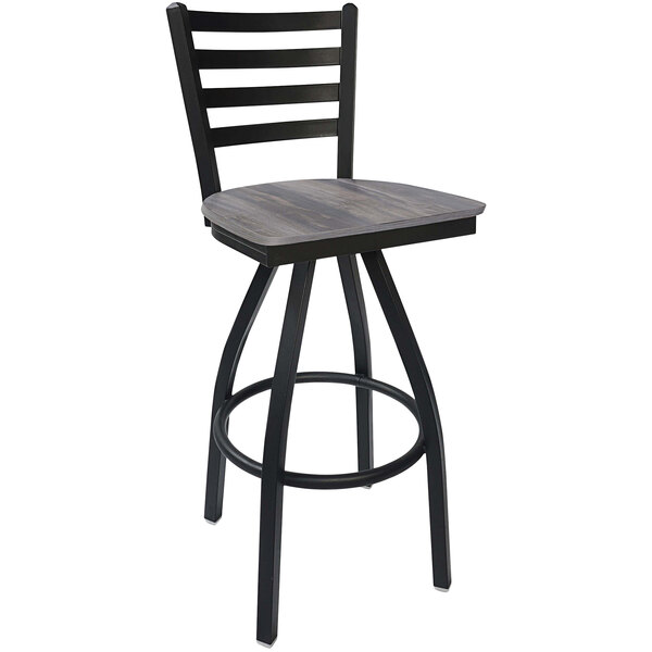 A BFM Seating black steel swivel bar stool with a wooden seat.