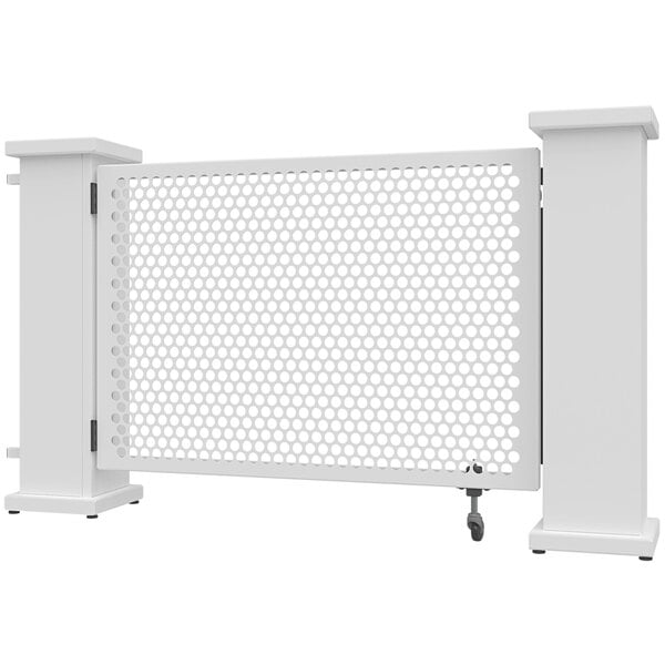 A white metal gate with a circle pattern and white planter stands on either side.