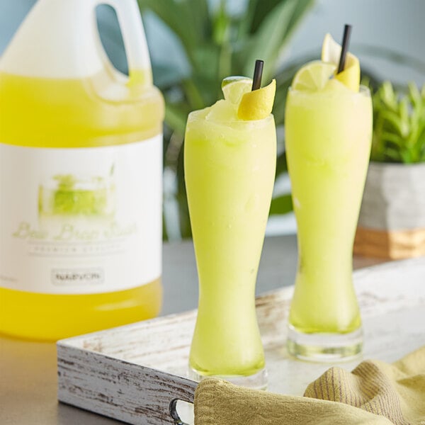 A tray of Narvon Dew Drop slushy drinks with yellow liquid.