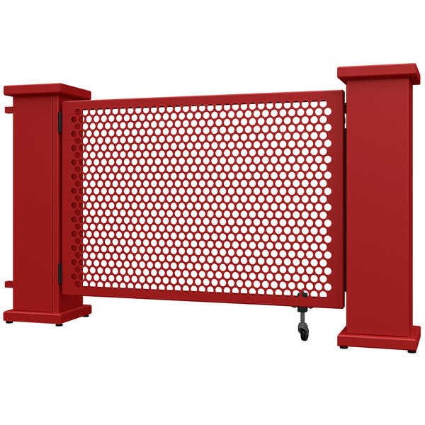 A red metal gate with white circle patterns.