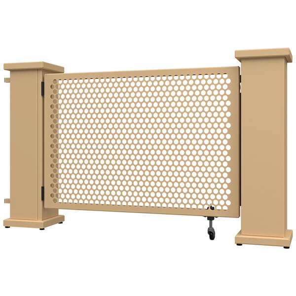 A beige metal fence panel with a circle pattern in the center and planter stands on each side.