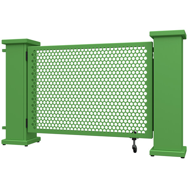 A green metal gate with a circle pattern and planter stands on the sides.