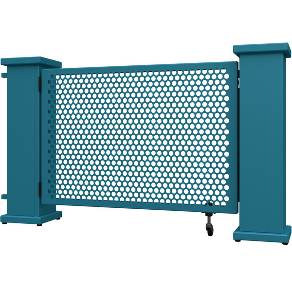 A teal metal gate with circle and corner planter stands and a circle pattern with holes in it.