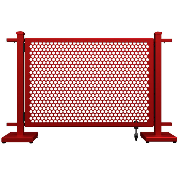 A red metal gate with white circle patterns.