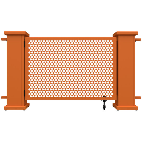A burnt orange metal gate with a circle pattern on the bottom and metal bars on top.