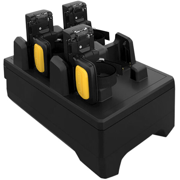 A black and yellow Zebra 4-slot charger for RS5100 ring scanners with several batteries.