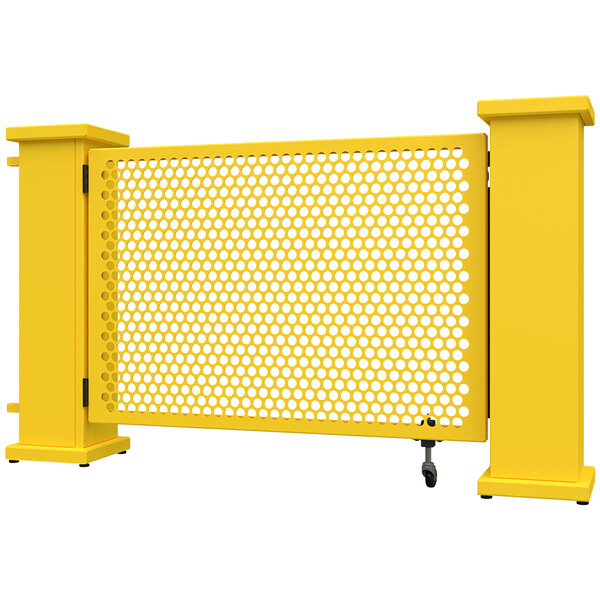 A yellow metal gate with a circle pattern and rectangular planter stands.