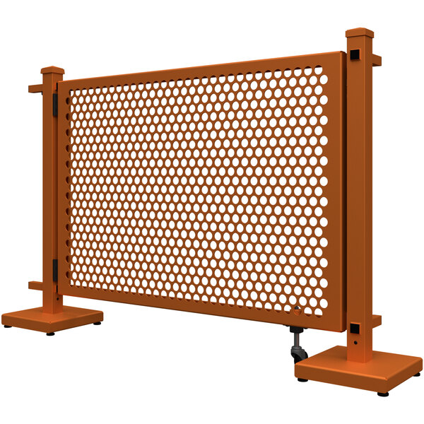 A burnt orange metal fence with a circle pattern and corner stands.