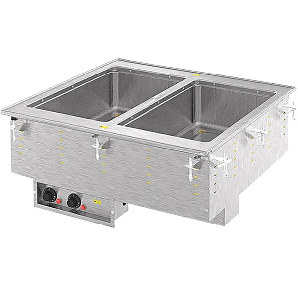 A Vollrath drop-in hot food well with two pans in a stainless steel counter.