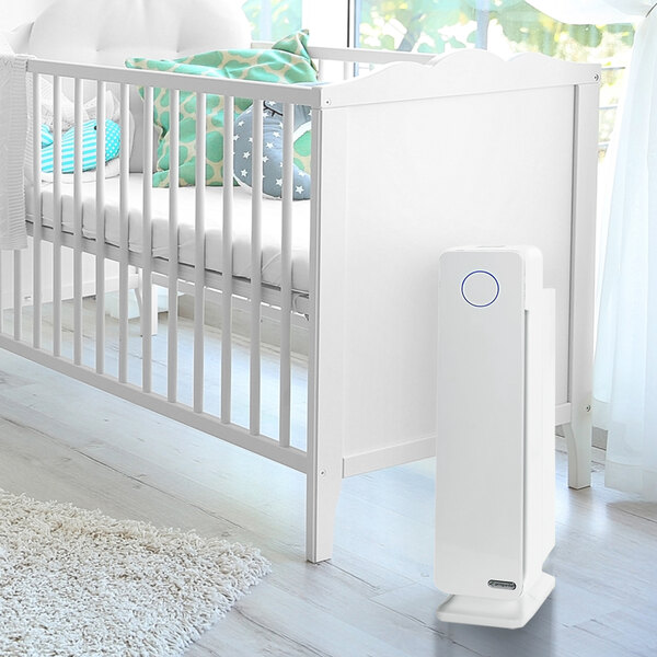 A white rectangular Guardian Technologies air purifier on a white crib.