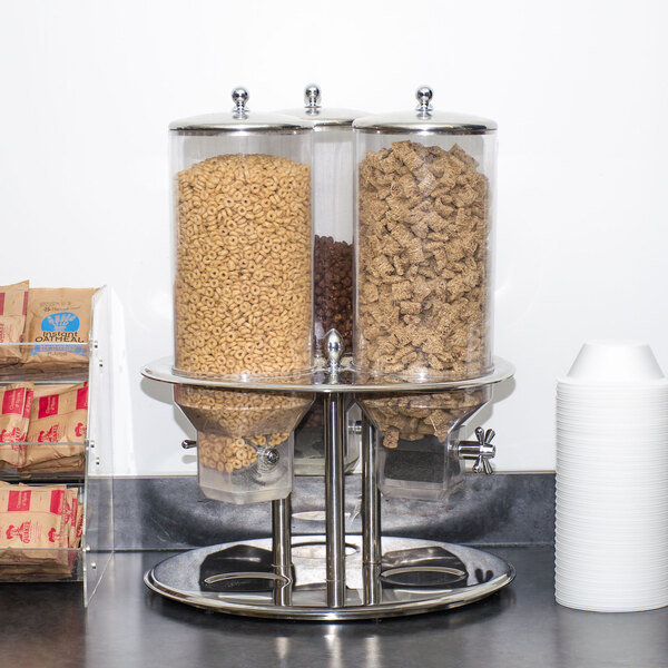 A Tablecraft stainless steel triple cereal dispenser filled with cereal.