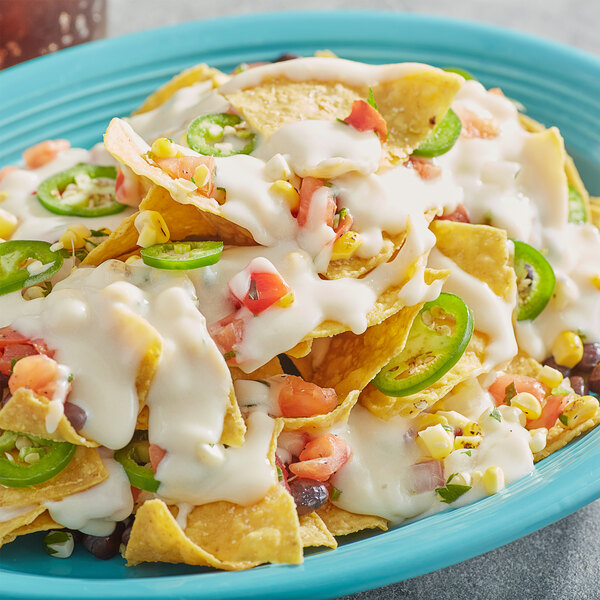 A plate of nachos with Chef-Mate White Cheddar Cheese Sauce.