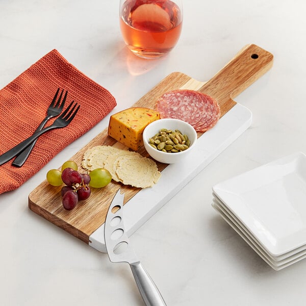 An Acopa acacia wood serving board with food on it.