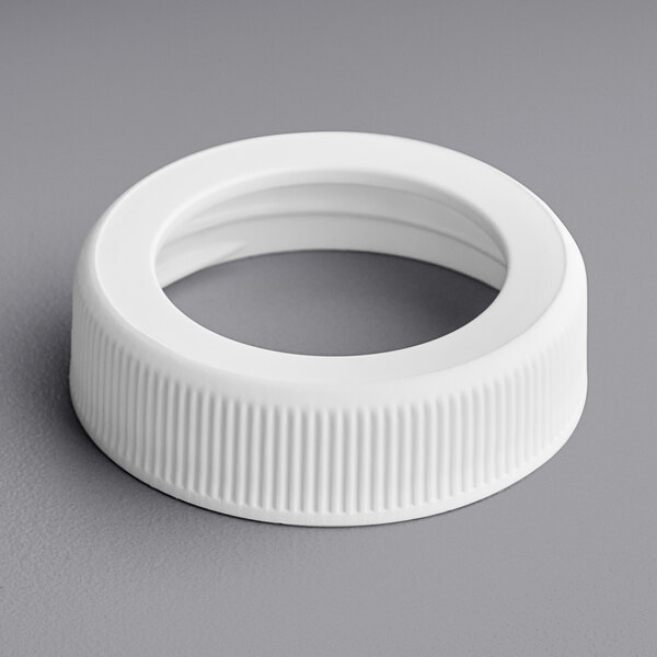 A white plastic cap with a hole.