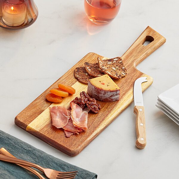 An Acacia wood serving board with food on it.