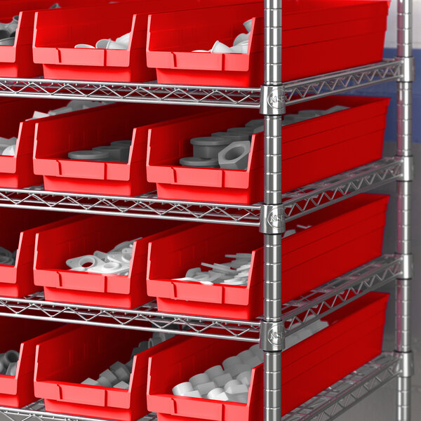 A red and silver shelving unit with a red bin full of white objects.