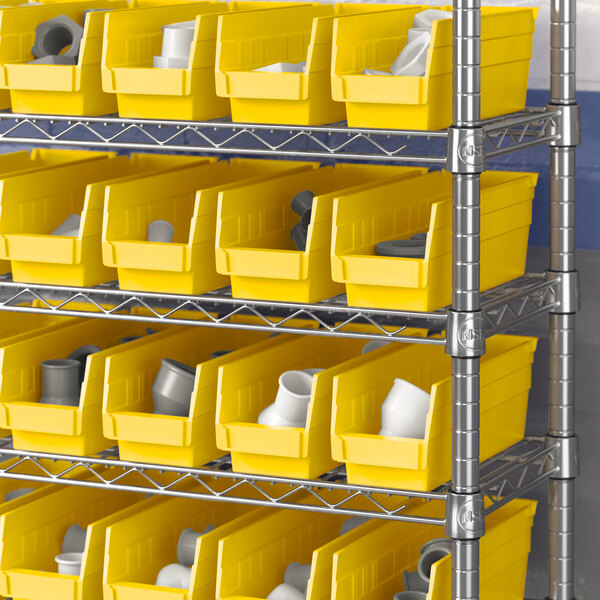 A shelf with yellow Regency shelf bins filled with white items.