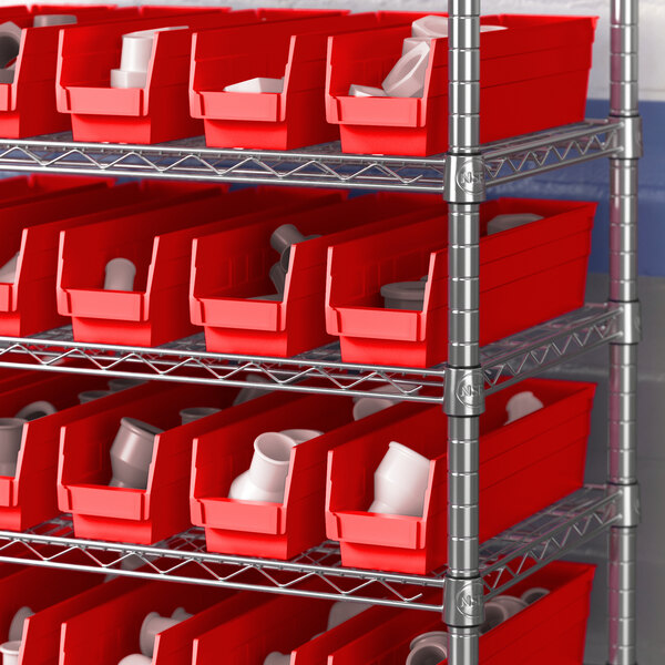 A metal shelving with red Regency shelf bins.