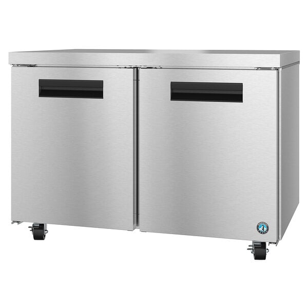 A stainless steel Hoshizaki undercounter freezer with black handles.