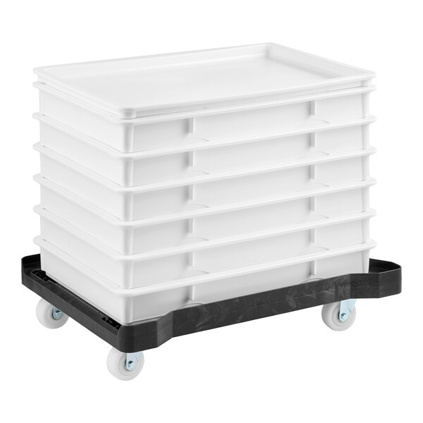 A set of six white dough proofing trays stacked on a black plastic dolly with wheels.