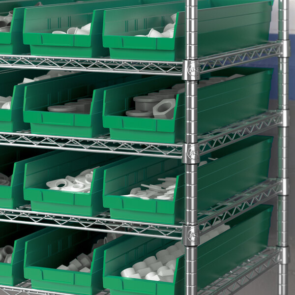 A shelf with green Regency shelf bins holding white cups.