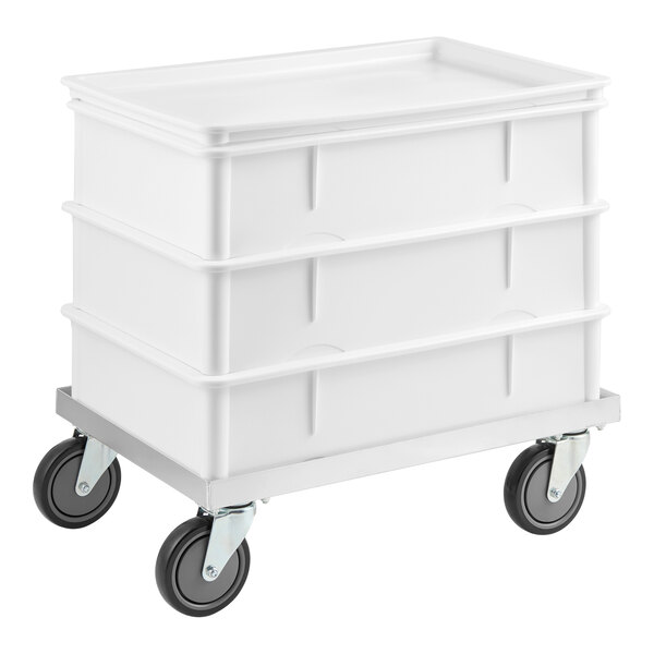 A white dough proofing set with three stackable bins and an aluminum dolly with four caster wheels.