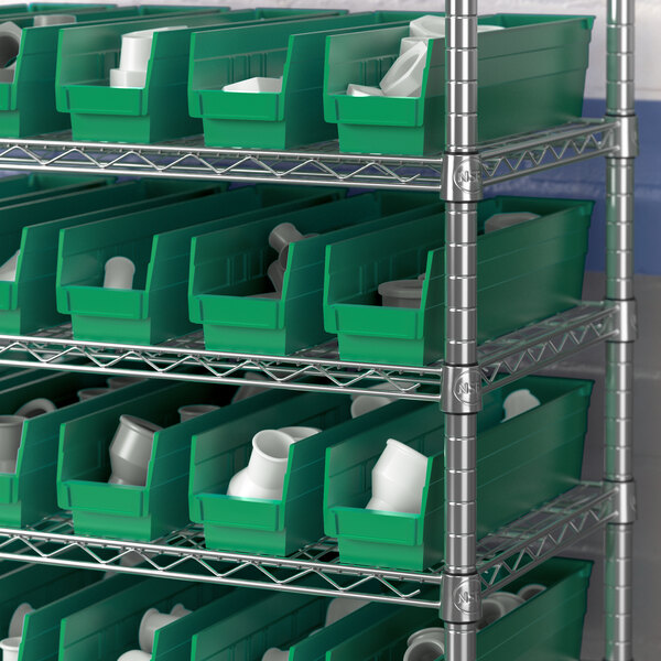 A shelf with several Regency green plastic bins filled with white plastic containers.