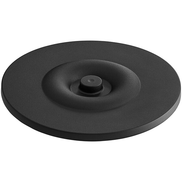 A black circular lid with a round center.