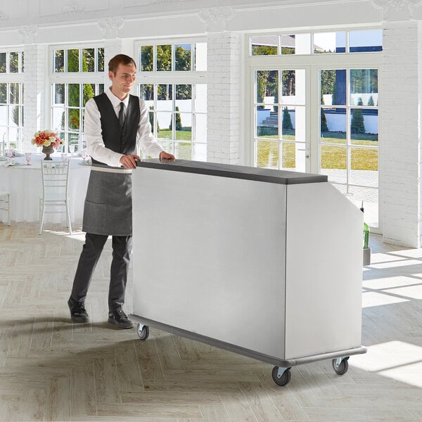 A man standing behind a Regency portable bar with a large white tray.