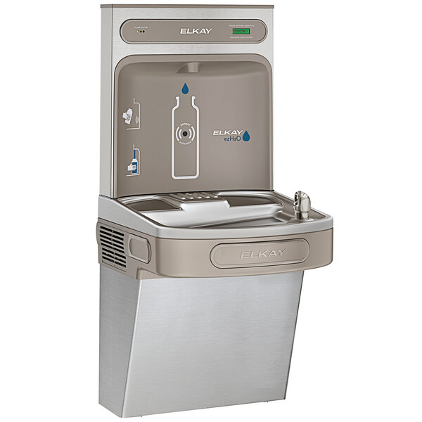 An Elkay stainless steel water fountain with a bottle filling station and logo above it.