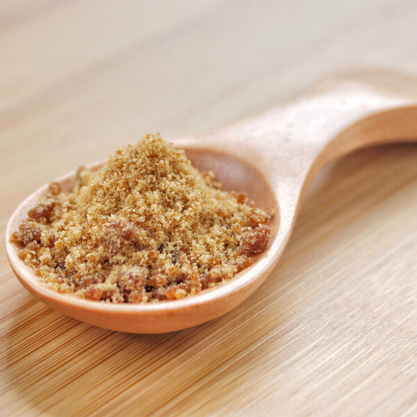 A spoonful of brown Panela sugarcane powder.