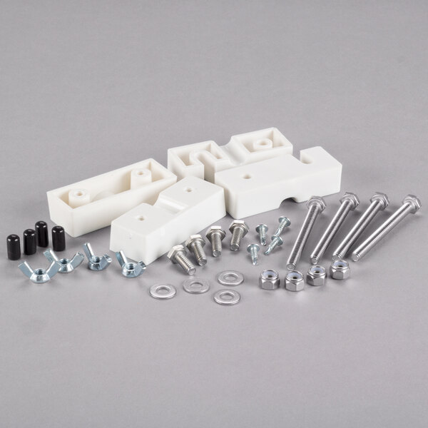 A white plastic VacPak-It bearing block with screws and nuts.