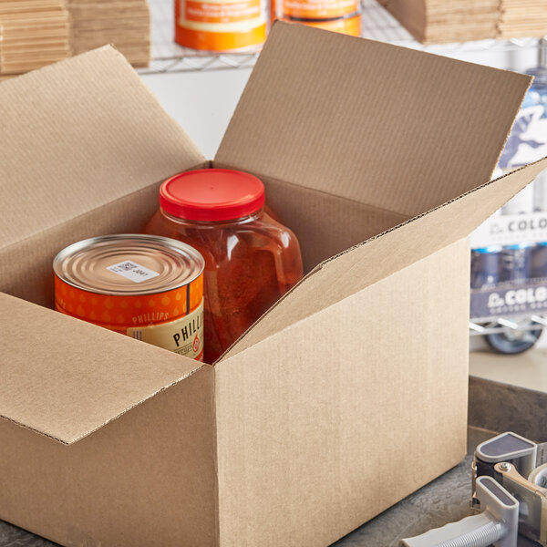 A Lavex corrugated shipping box with containers and cans of food inside.
