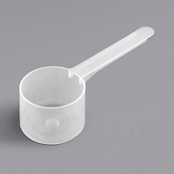 A white plastic measuring scoop with a long handle.