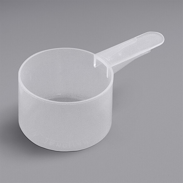 A white plastic measuring scoop with a short handle.