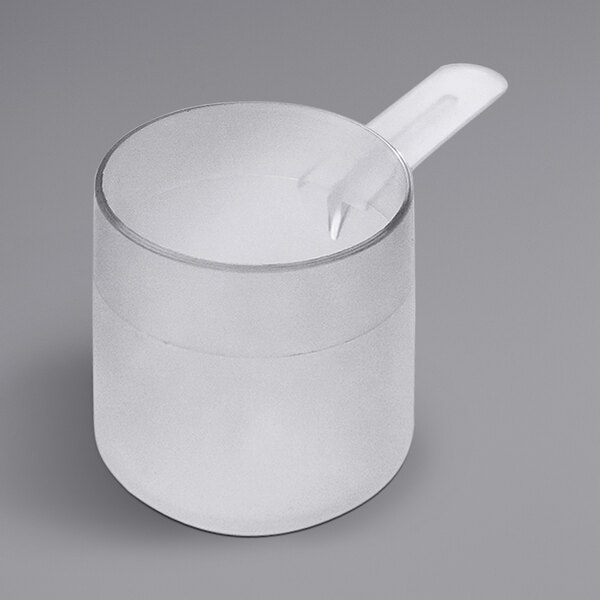 A clear plastic cup with a medium handle and a scoop on top.