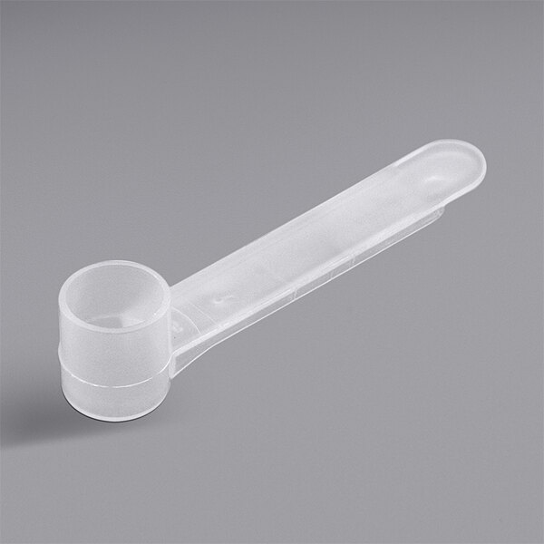 A clear plastic measuring scoop with a white handle.