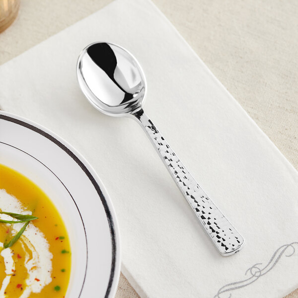 A Visions silver plastic spoon on a white napkin.