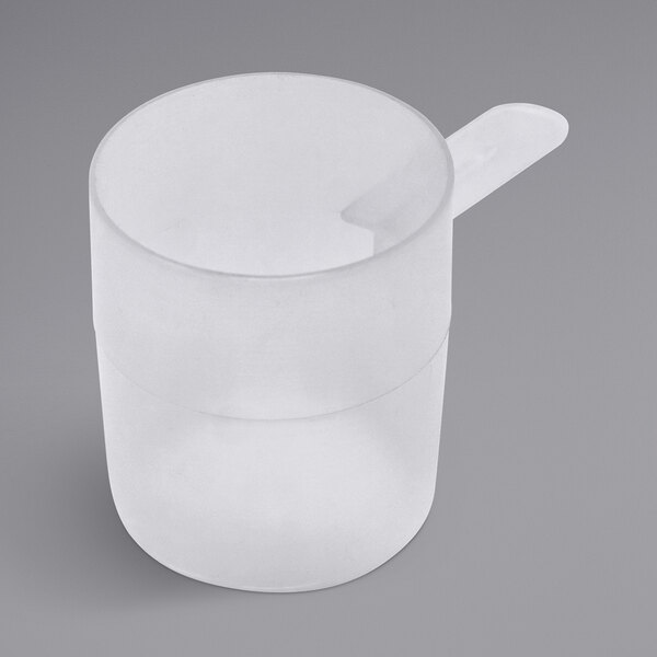 A clear plastic cup with a white polypropylene scoop on top.