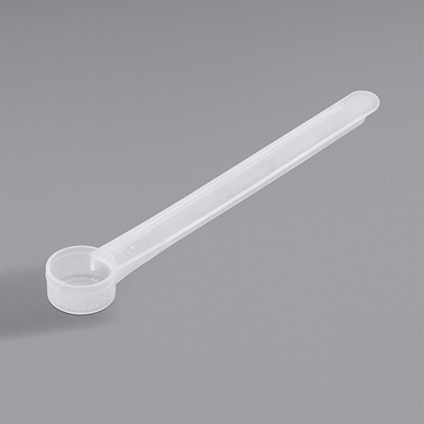 A 3 cc polypropylene measuring spoon with a long handle.
