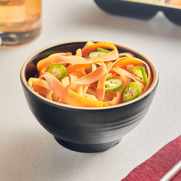 An Acopa Ugoki melamine bowl with noodles and jalapenos on a table.
