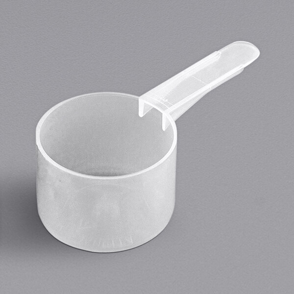 A white plastic measuring scoop with a medium handle.