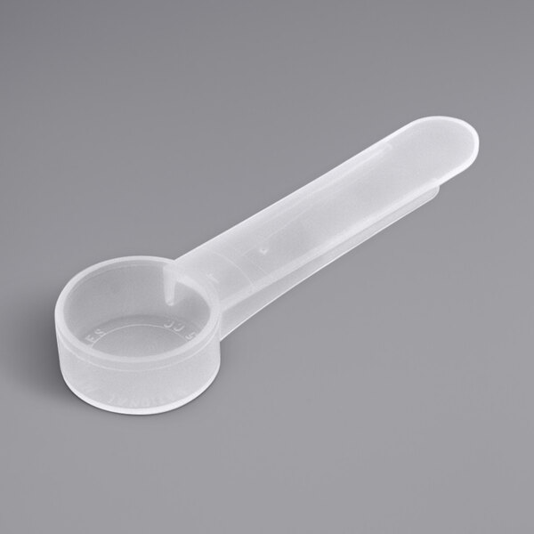 A polypropylene measuring spoon with a handle.