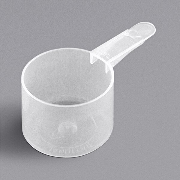 A clear plastic scoop with a plastic handle.