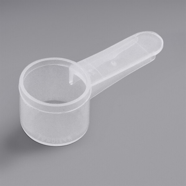A close-up of a white 6 cc polypropylene scoop with a short handle.