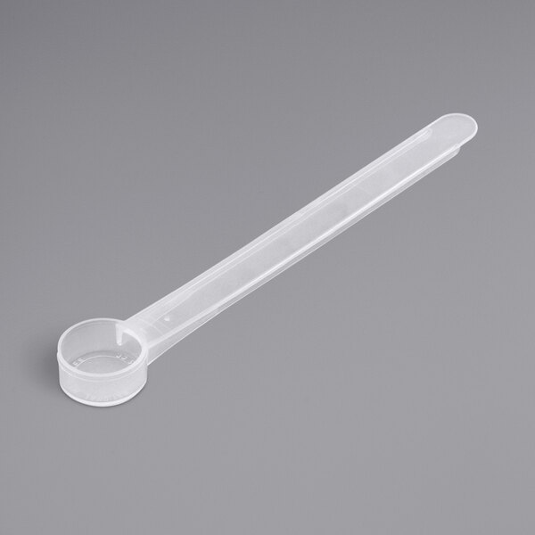 A clear plastic 3.5 cc polypropylene scoop with a long handle.