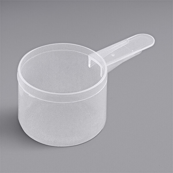 A clear plastic container with a 55 cc polypropylene scoop with a short handle on top.