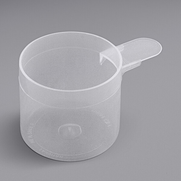 A clear plastic measuring scoop with a short handle.